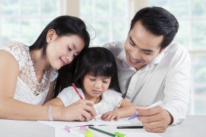 Girl In Homeschooling With Their Parents