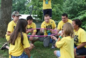 Soldiers_happy_to_help_kids_at_Camp_SOS_130711-A-LS265-014